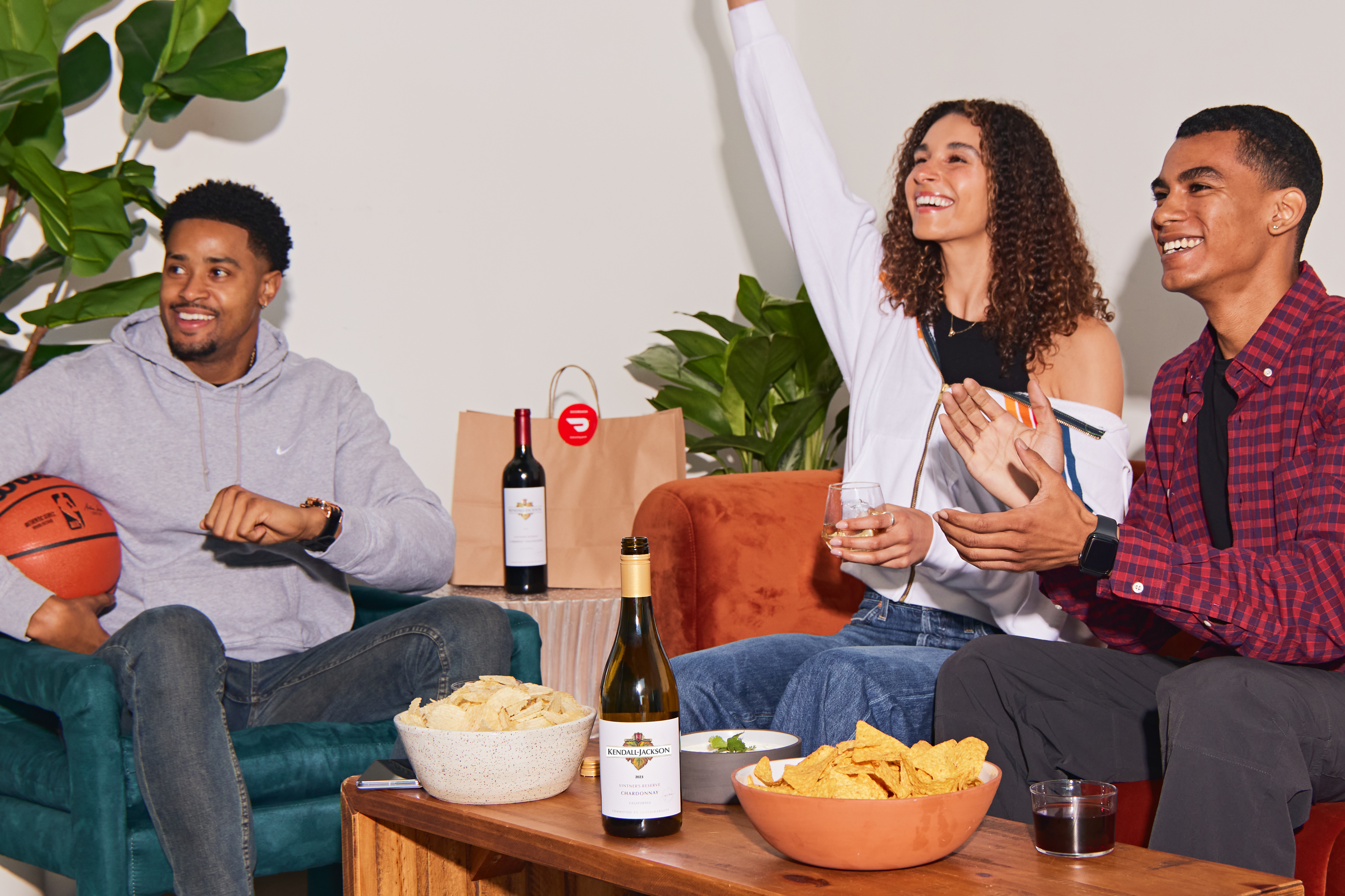 NBA Fans watching a game & cheering on a couch with Kendall-Jackson wines