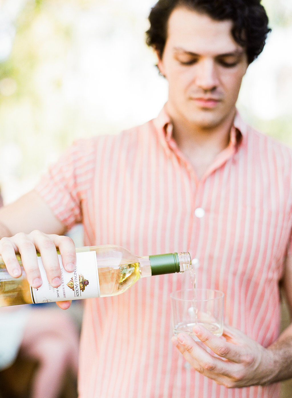 Pouring Sauvignon Blanc wine into a glass